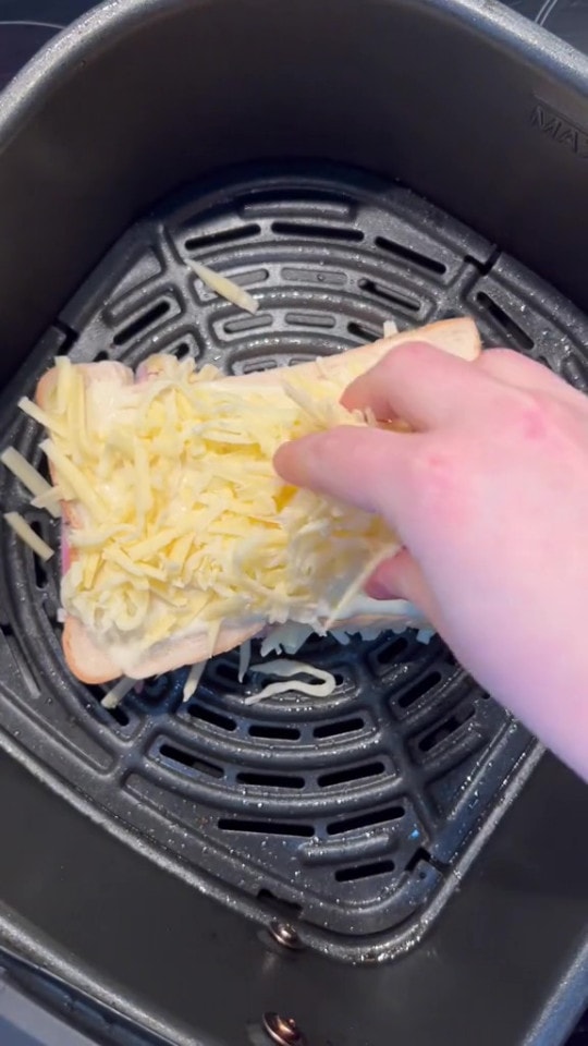 She then topped it with more cheese before cooking in the air fryer - I Make The Ultimate Cheese And Ham Toastie In My Air Fryer With My 85p Hack &amp; It Tastes As Good As Costa's